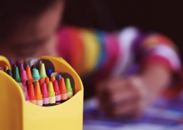 Yellow container filled with colorful crayons symbolizing clear vision for school leaders.