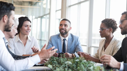 Business professionals discussing sustainable leadership strategies in a green conference setting.