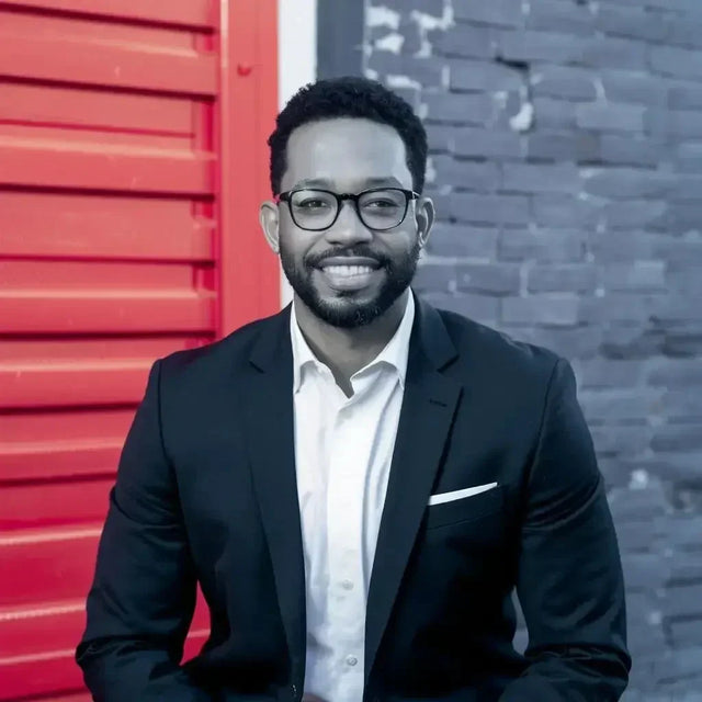 Man in a suit and glasses symbolizing continuous learning in today’s fast-paced world.