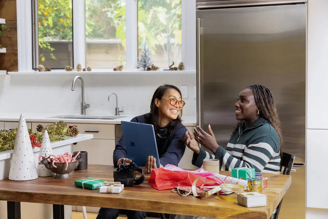 Two individuals engaged in a lively discussion at a kitchen table, highlighting social connections.