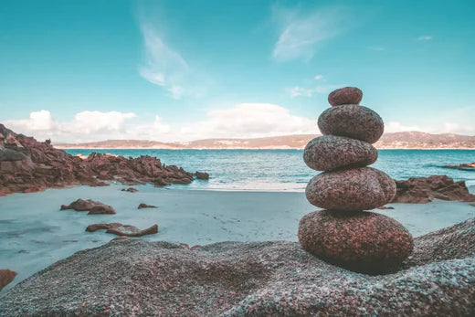 Stack of smooth stones in a cairn symbolizing balance in a fast-paced work environment