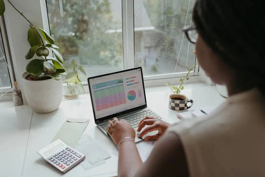 Laptop displaying colorful charts illustrating positive work culture and hustle culture.