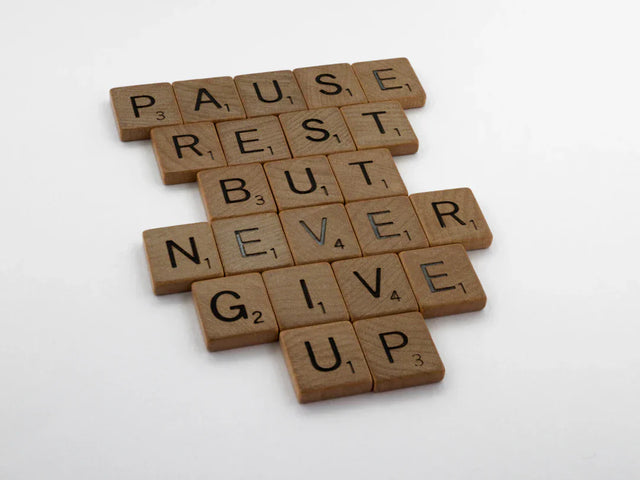 Scrabble tiles forming a motivational phrase related to vision board and support network