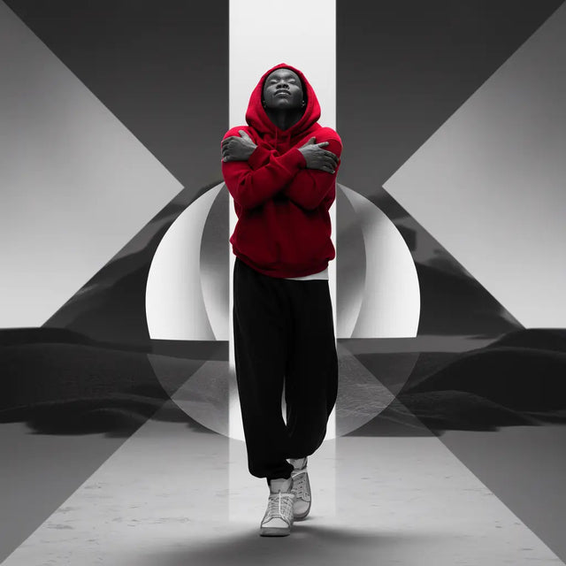 Man in a red hoodie standing before a white cross symbolizing hustle culture and mindfulness.