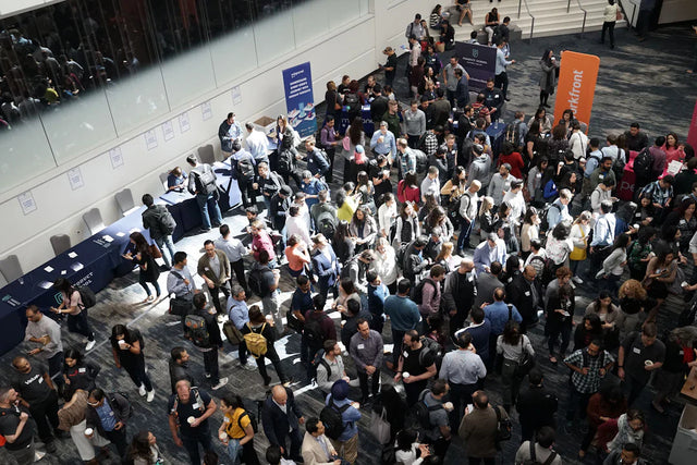 Crowd of people at a conference promoting personal growth and unlocking opportunities through networking
