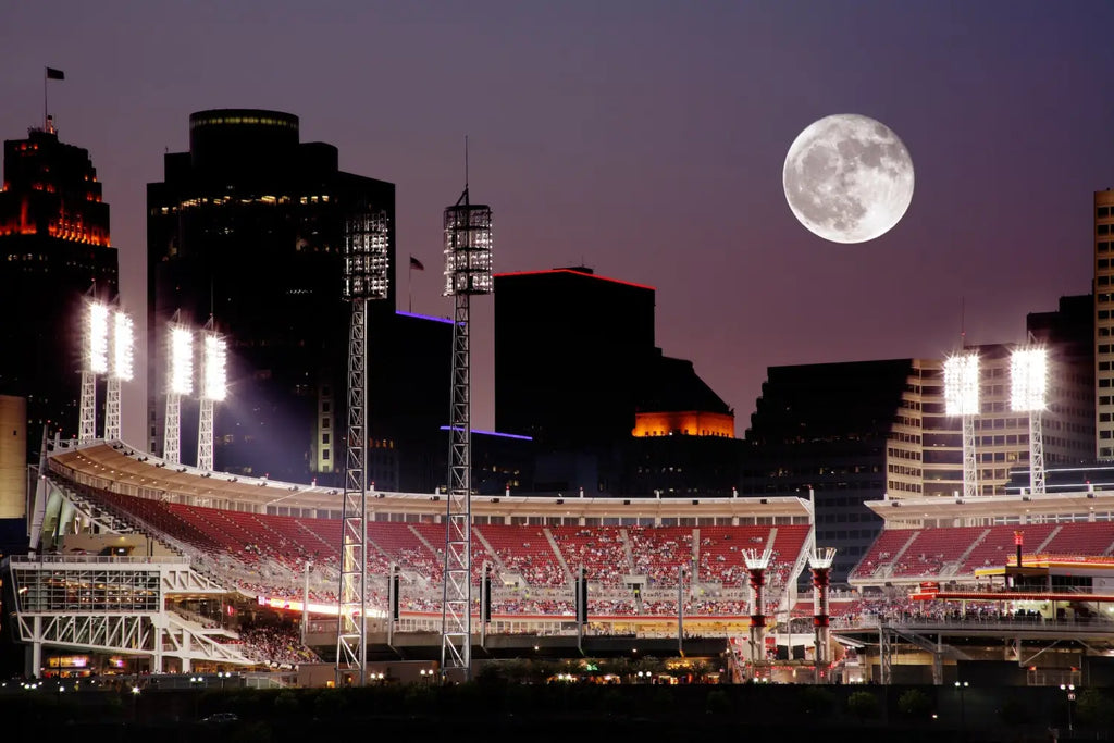 Baseball stadium lit by floodlights under a full moon, showcasing Cincinnati’s entrepreneurial spirit.