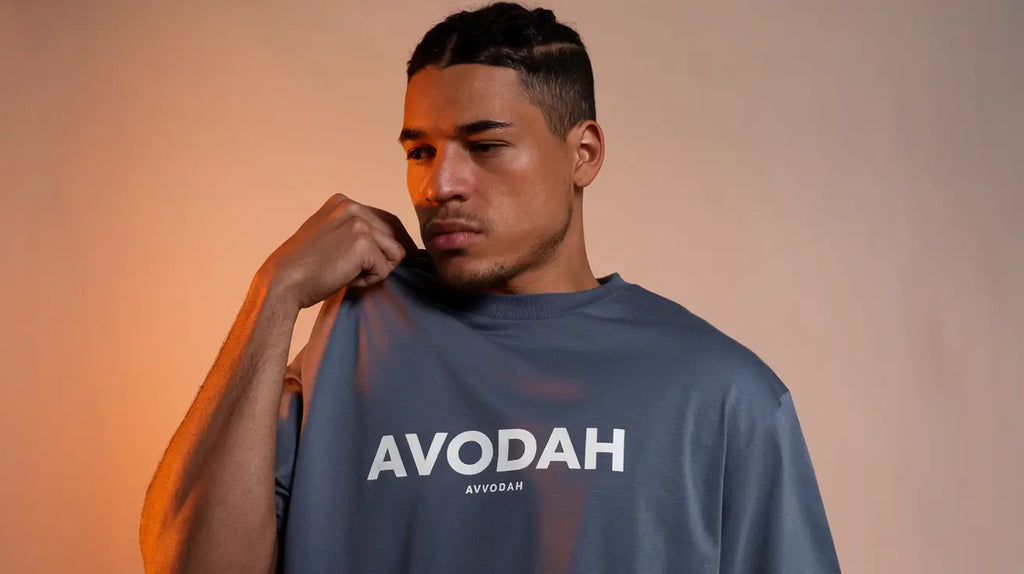 Gray sweatshirt featuring AVODAH text, embodying urban fashion and hustle culture.