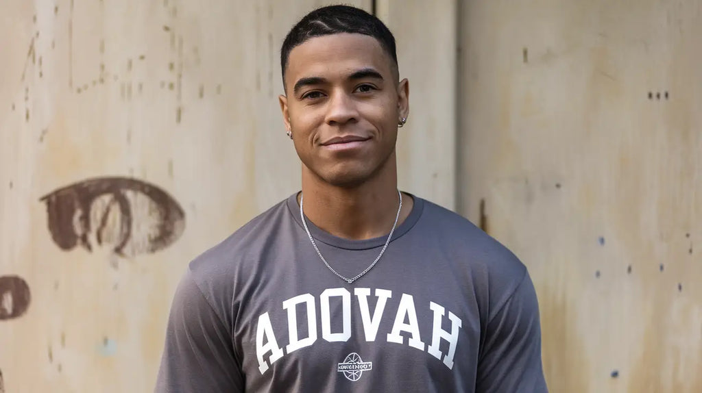 Athletic young man in a grey ADOVAH t-shirt promoting faith inspired hustle culture.