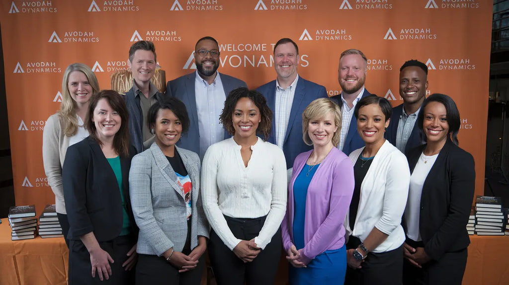 Group photo of motivational speakers promoting hustle culture at Avodah Dynamics event.