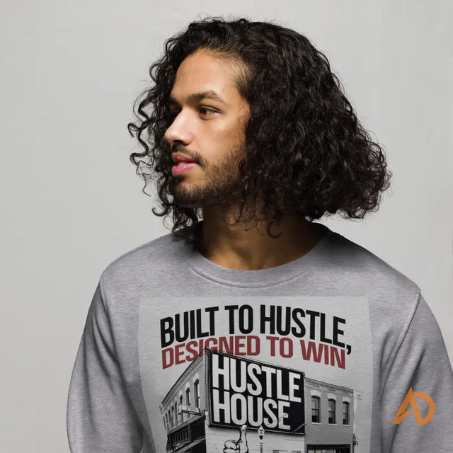 Person with long curly dark hair in a Built to Hustle gray shirt from Avodah Dynamics