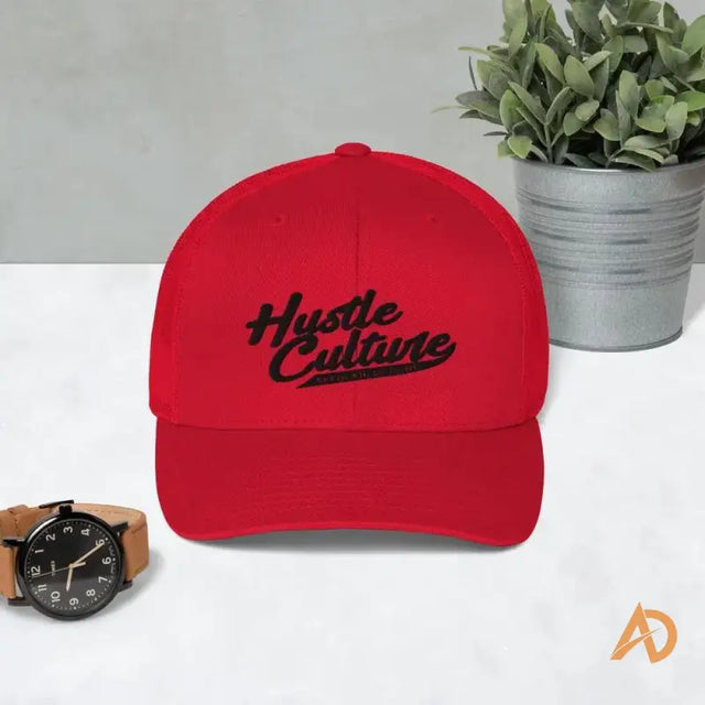 Close up of Classic Hustle Culture Trucker Cap with a watch and plant