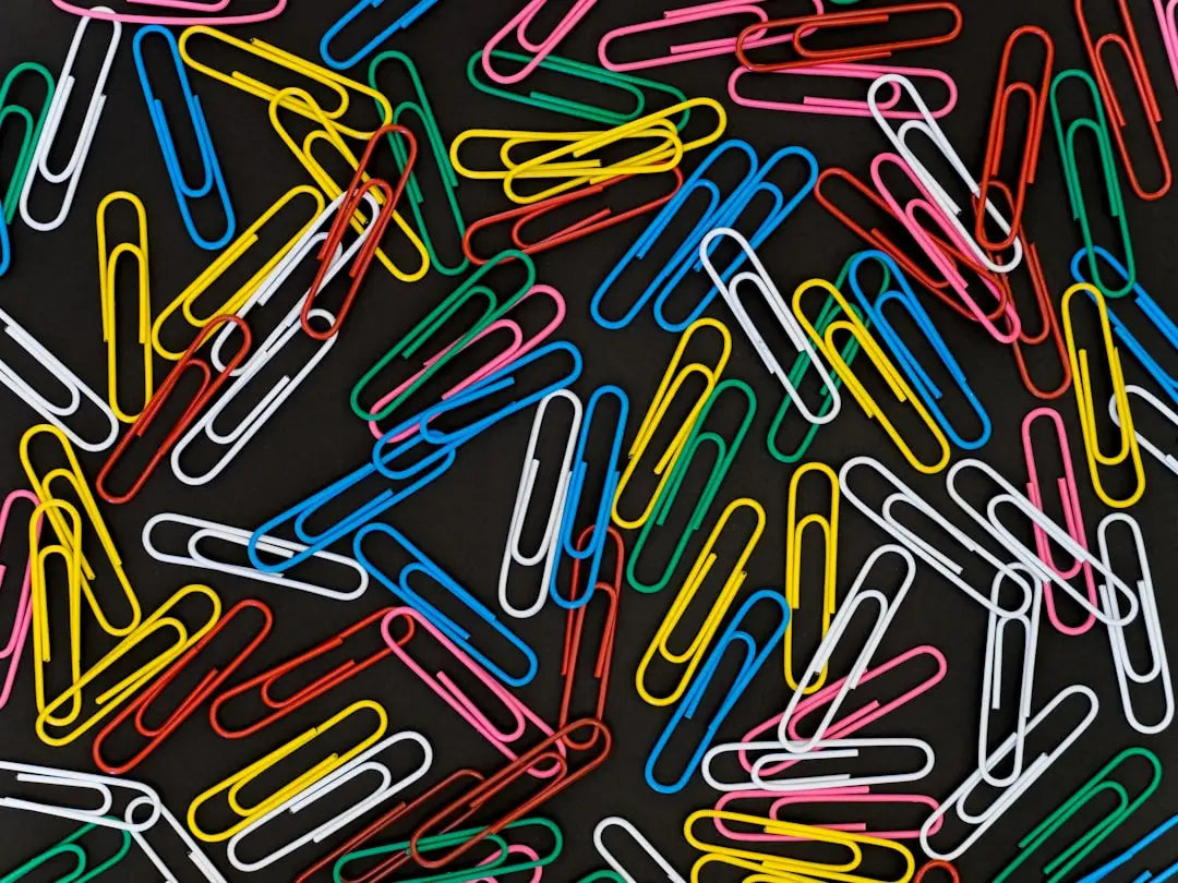 Colorful paper clips scattered, symbolizing the transformative power of Christian work ethic.