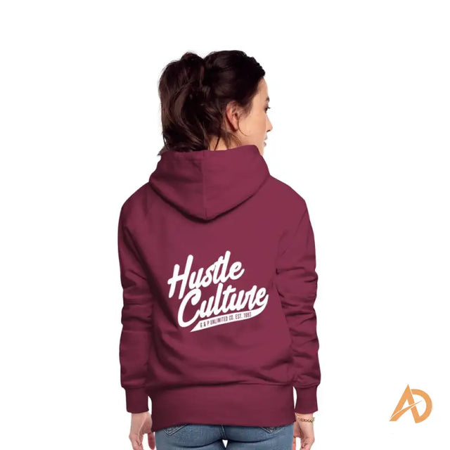 Woman in Empowerment Hoodie by Hustle Culture, featuring a maroon design with Hut