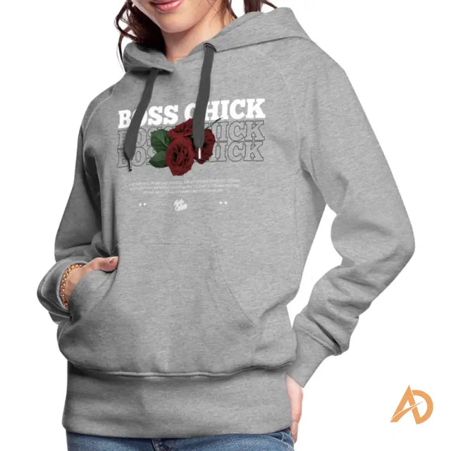 Woman in Empowerment Hoodie by Hustle Culture featuring a rose graphic design