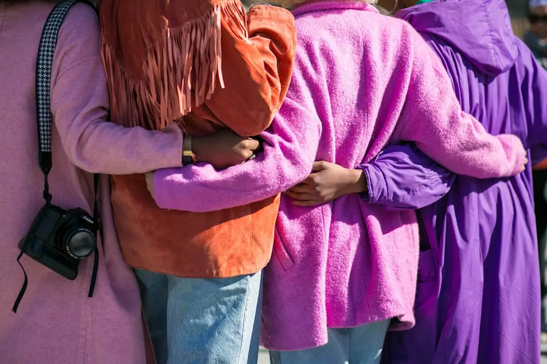 Four women in colorful textured clothing practicing mindfulness for stress management techniques