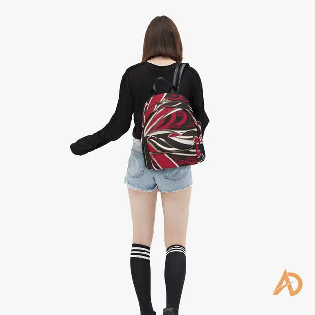 Red and white patterned Geometric Signature Paisley Backpack paired with casual attire