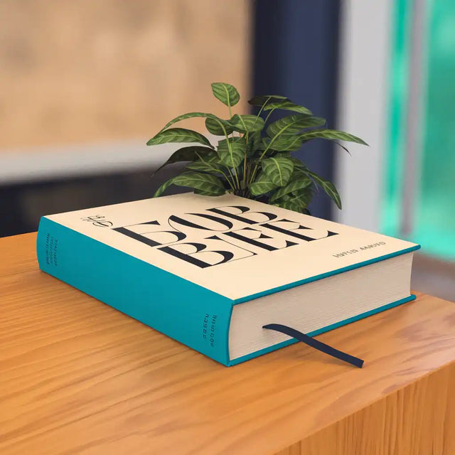 Turquoise hardcover book with a small plant growing from its pages