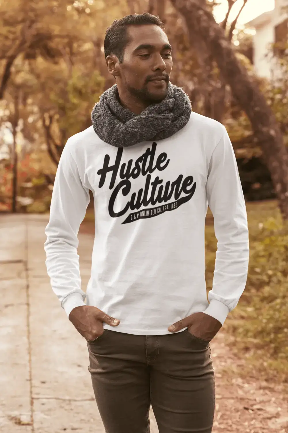 White long-sleeve shirt with Hustle Culture graphic paired with gray knit scarf, redefining hustle.