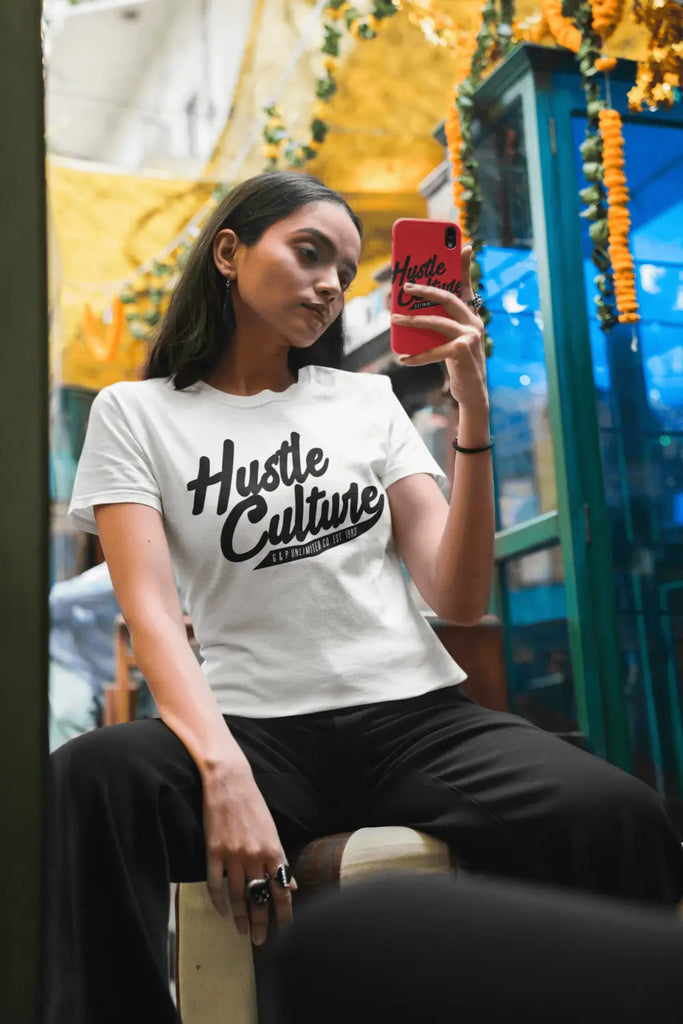 White t-shirt featuring Hustle Culture text, symbolizing work ethic and professional development.