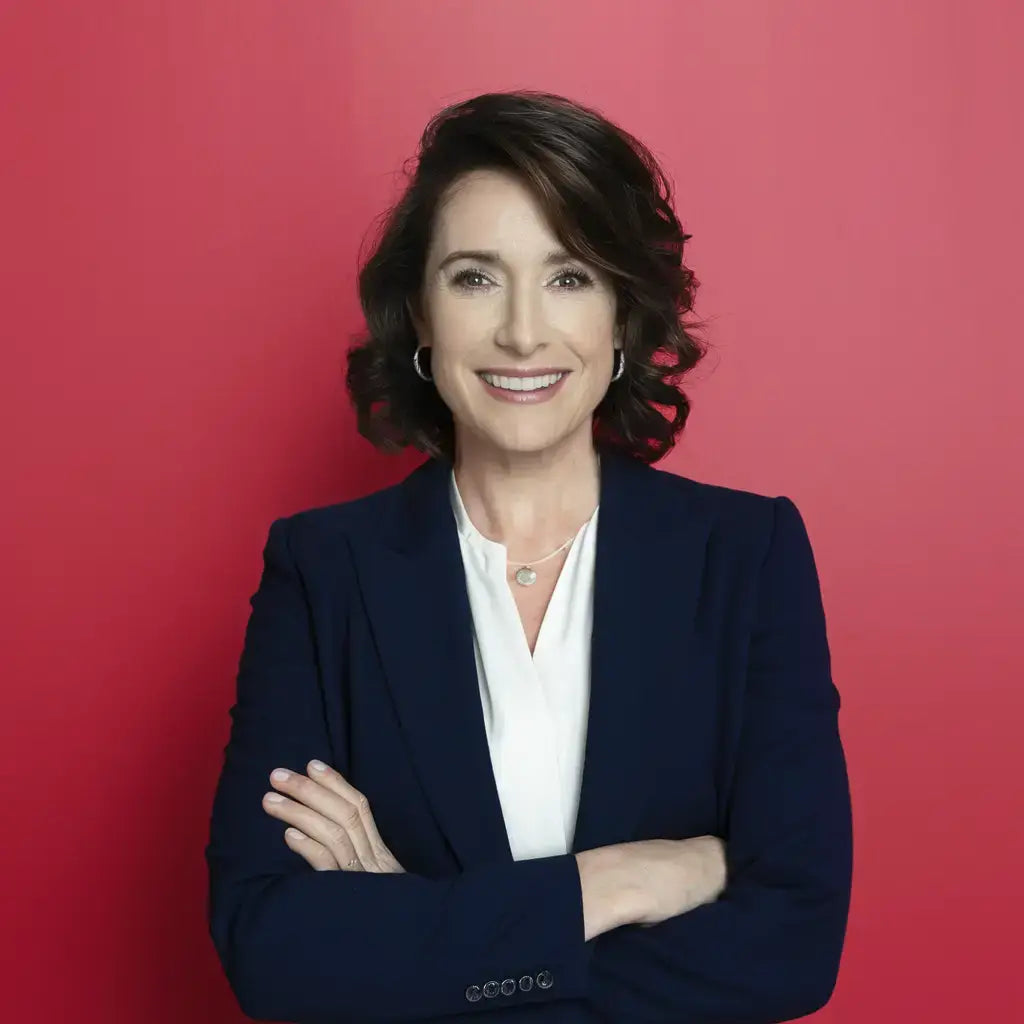 Professional headshot of an individual in navy blazer, emphasizing leadership skills and self-awareness.