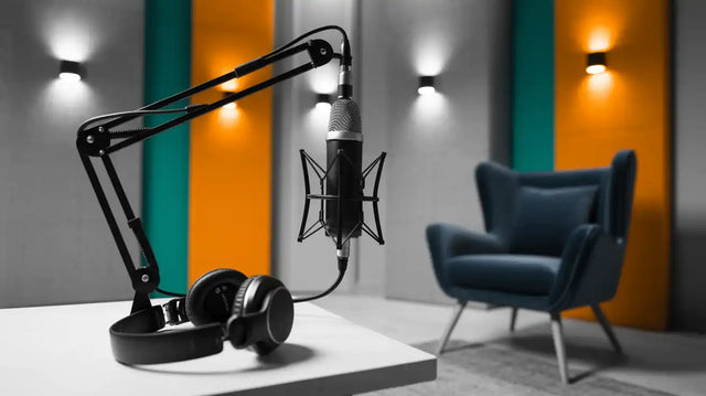 Professional podcasting setup with a condenser microphone, shock mount, boom arm, and headphones.