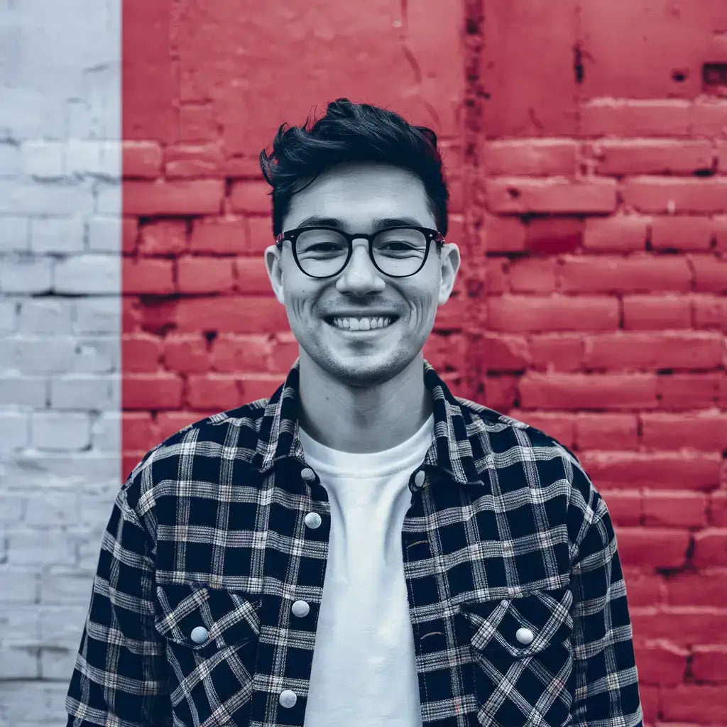 Smiling person in glasses and plaid shirt promoting emotional intelligence in decision making.