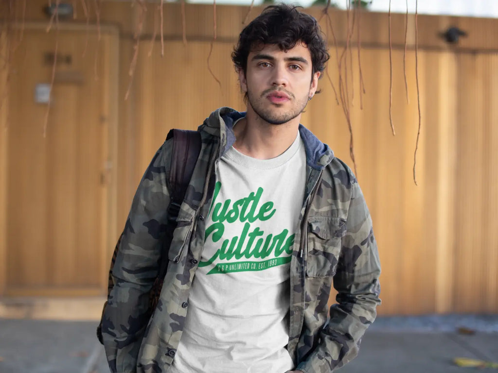 Person in camouflage jacket and white Hustle Culture t-shirt promoting unlimited lifestyle.